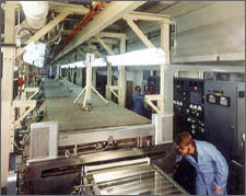 Photo of two workers in a manufacturing line.