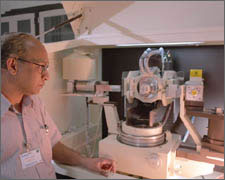 Photo of a researcher checking a sample on an x-ray diffraction (XRD) system.