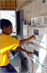 Photo of a student at the 2002 Solar Decathlon competition in Washington, D.C., working on her team's power conditioning equipment.