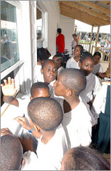 Photo of students of all ages learning about everyday solar applications at the Solar Decathlon Village in Washington, D.C.