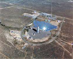 Photo of the National Solar Thermal Test Facility, which is located at Sandia National Laboratories and sits on 110 acres of land. This aerial photo shows the different concentrating solar power technologies like the central tower with 222 heliostats and parabolic dishes surrounded by extensive acreage. 