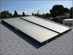 Photo of a two solar collectors on a roof. 