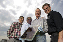 Photo of the four AVA Solar founders (Pascal Noronha, W.S. Sampath, Al Enzenroth, and Kurt Barth) holding one of their thin-film photovoltaic modules.
