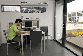 Photo of a young man sitting at desk reading.