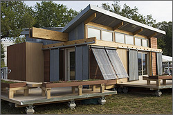 Photo of home with evacuated-tube solar water heating collectors. 