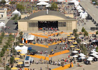 Photo of the Orange County Great Park where crowds of people and event buildings occupy a former air strip.