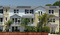 Photo of connected houses that have building-integrated photovoltaic roof shingles