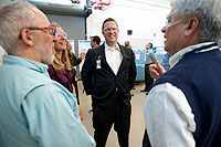 Photo of Assistant Secretary Danielson standing with three people who are wearing safety glasses.