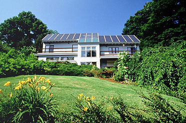 Photo of a house with solar panels covering the roof.