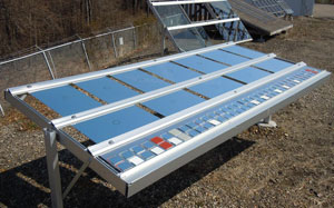 Photo of a metal stand with flat square-shaped pieces lined up in three rows.