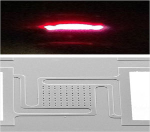 Image of a fire-red glow above an image of small holes in the center of a flat place with grooves