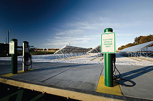 Image of two electric vehicle parking spaces with charging stations and signs that read "Electric Vehicle Parking Only."