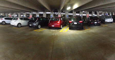 plug-in electric vehicles parked at charging stations in parking garage