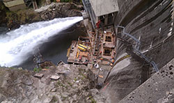 Photo of water pouring out of the Cushman Dam.