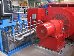 Photo of a turbine inside of a power plant.