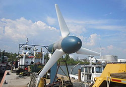 Photo of a turbine designed for the ocean situated on the shore.
