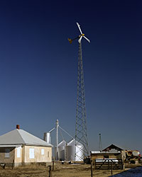 Photo of a small wind turbine on a farm.