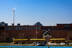 Photo of a turbine behind a school.