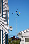 A Bergey windmill next to apartments