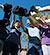 Photo of volunteers high fiving paint mitts after painting the fence during a volunteer outing.