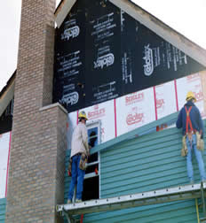 Two builders on a ladder working on a building Two builders on a ladder working on a building