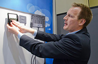 PHoto of a man demonstrating how the components of a PV docking system work.