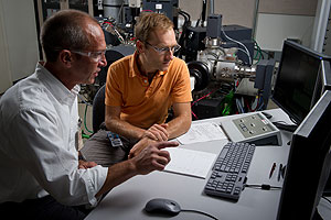 Photo of two male researchers looking at results on a computer screen.